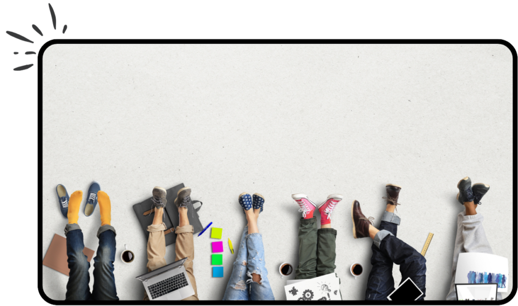 6 adults sat off camera with legs visible surrounded by post-it notes, laptops and coffee cups.